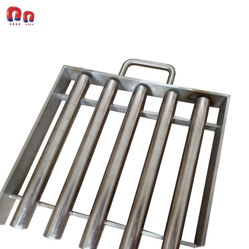 Metal grate with cylindrical bars, handle. Magnets for industrial use, metallic.